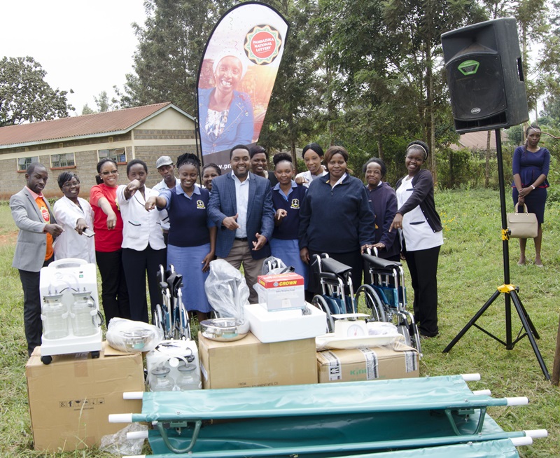 link : Maragua District Level 4 District hospital staff receiving the medical equipment from the Pambazuka National Lottery team. uliza
